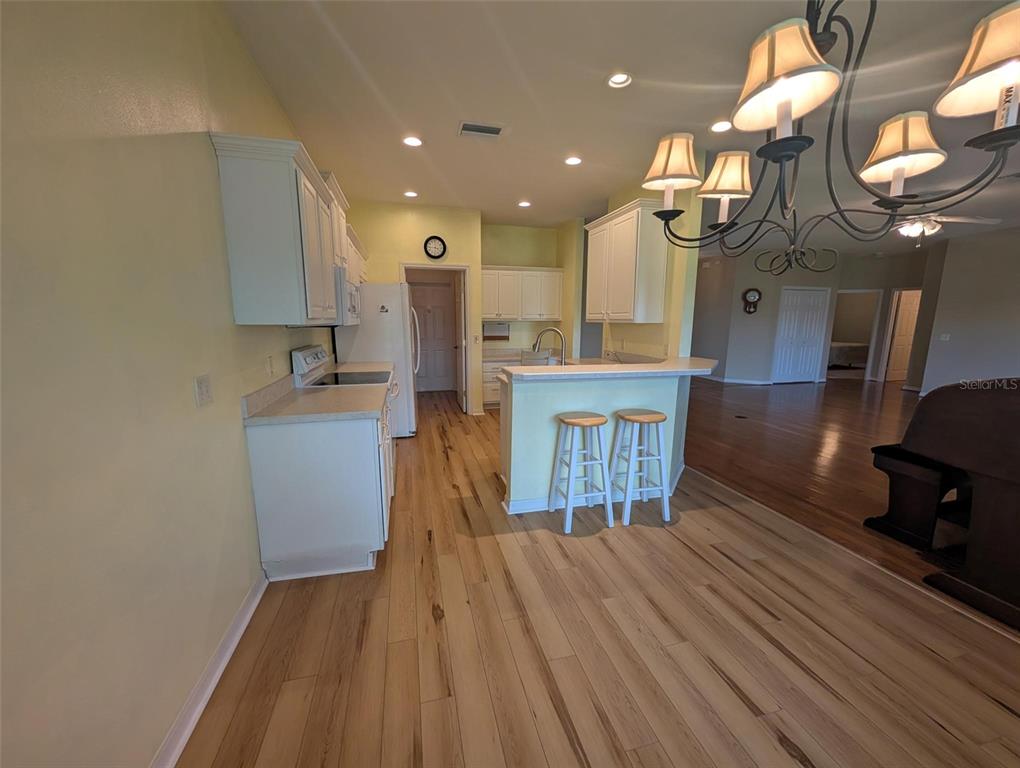 4124 Muirfield Loop Lake Wales, FL 33859 - Photo 10 of 29 a view of a kitchen with cabinets and wooden floor