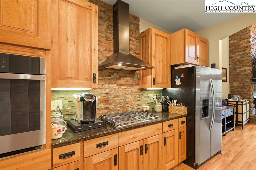 138 South Camp Road, Unit 103 Boone, NC 28607 - Photo 13 of 50 a kitchen with stainless steel appliances a refrigerator sink and cabinets