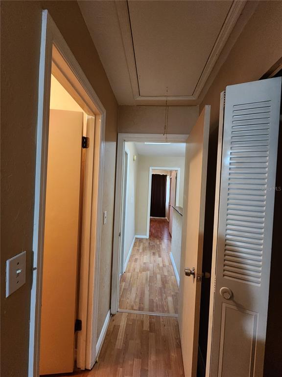 6288 Southwest 8th Place Gainesville, FL 32607 - Photo 16 of 21 a view of a hallway with wooden floor and staircase