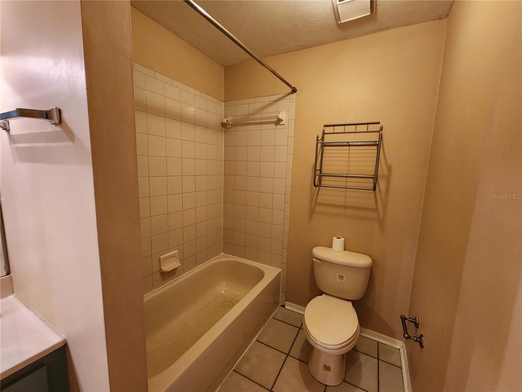 6288 Southwest 8th Place Gainesville, FL 32607 - Photo 17 of 21 a white toilet sitting next to a bath tub