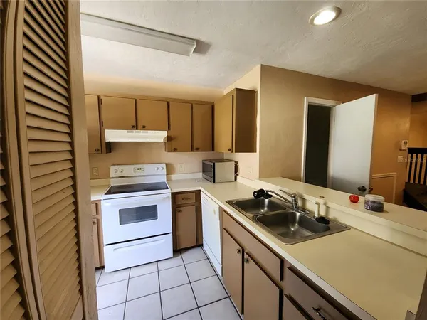 a kitchen with a sink appliances and cabinets