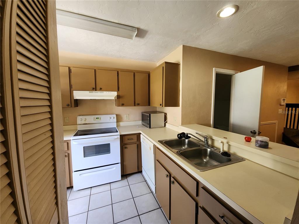 6288 Southwest 8th Place Gainesville, FL 32607 - Photo 2 of 21 a kitchen with a sink appliances and cabinets