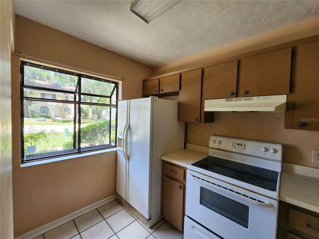 6288 Southwest 8th Place Gainesville, FL 32607 - Photo 3 of 21 a kitchen with a stove a refrigerator and a sink
