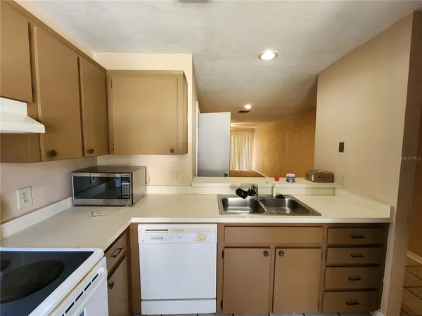 a kitchen with a sink a stove and cabinets