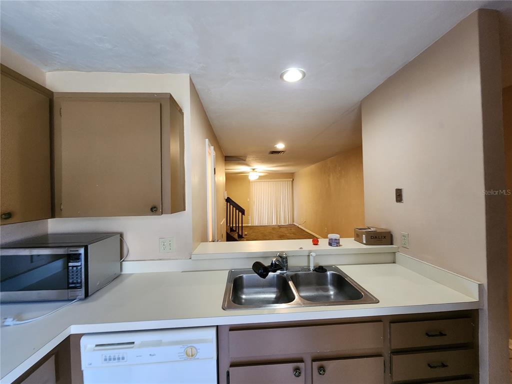 6288 Southwest 8th Place Gainesville, FL 32607 - Photo 8 of 21 a kitchen with a sink cabinets and window