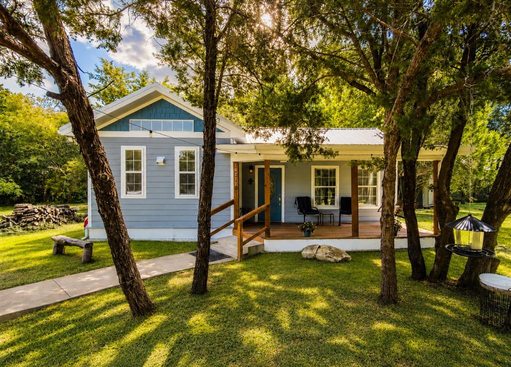 14275 Gholson Road Gholson, TX 76705 - Photo 2 of 22 Light blue siding exterior with a metal roof and a prominent front porch