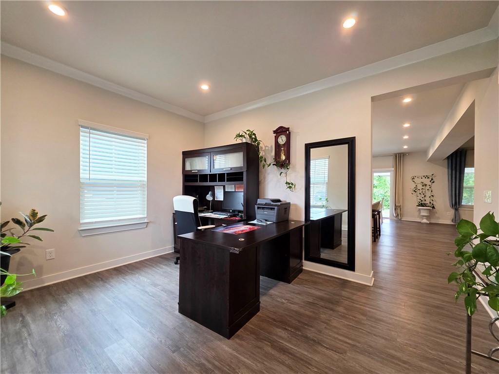 224 Bronson Ridge Anderson, SC 29621 - Photo 2 of 42 An inviting home office boasts rich wood flooring and crown molding, creating an ideal workspace.