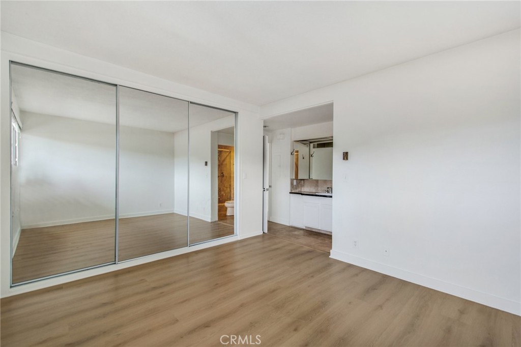 330 Cliff Drive, Unit 308 Laguna Beach, CA 92651 - Photo 13 of 16 a view of an empty room with wooden floor and a bathroom