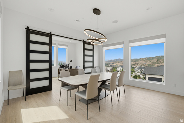1445 Jacob Road Sandy, UT 84092 - Photo 11 of 52 Expansive windows, wood-finish flooring, modern chandelier, recessed lighting, and barn doors