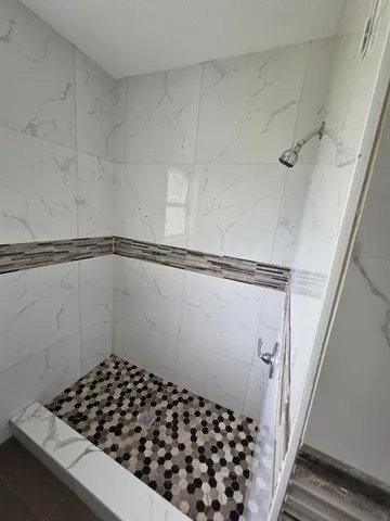 a bathroom with a window and a shower