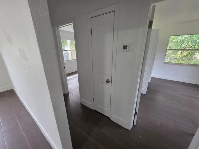 a view of a hallway with wooden floor
