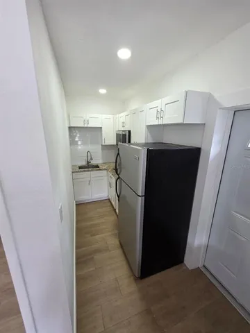 a view of a kitchen with refrigerator and microwave