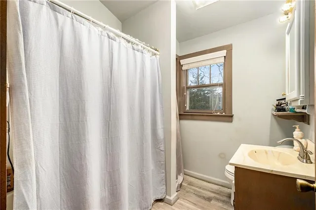 a bathroom with a sink a mirror and a shower curtain