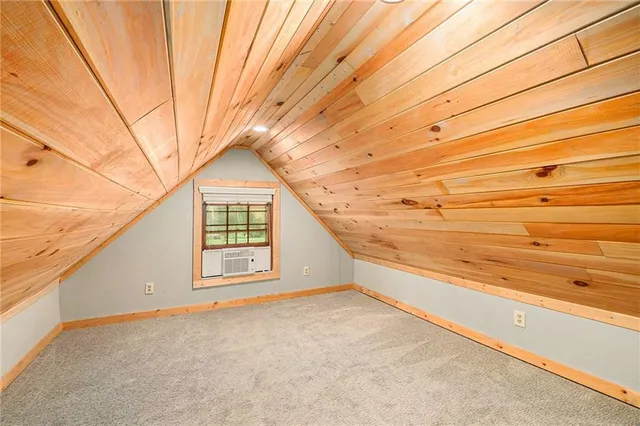 a view of a big room with wooden floor and brick walls