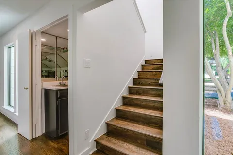 a view of staircase with white walls and windows
