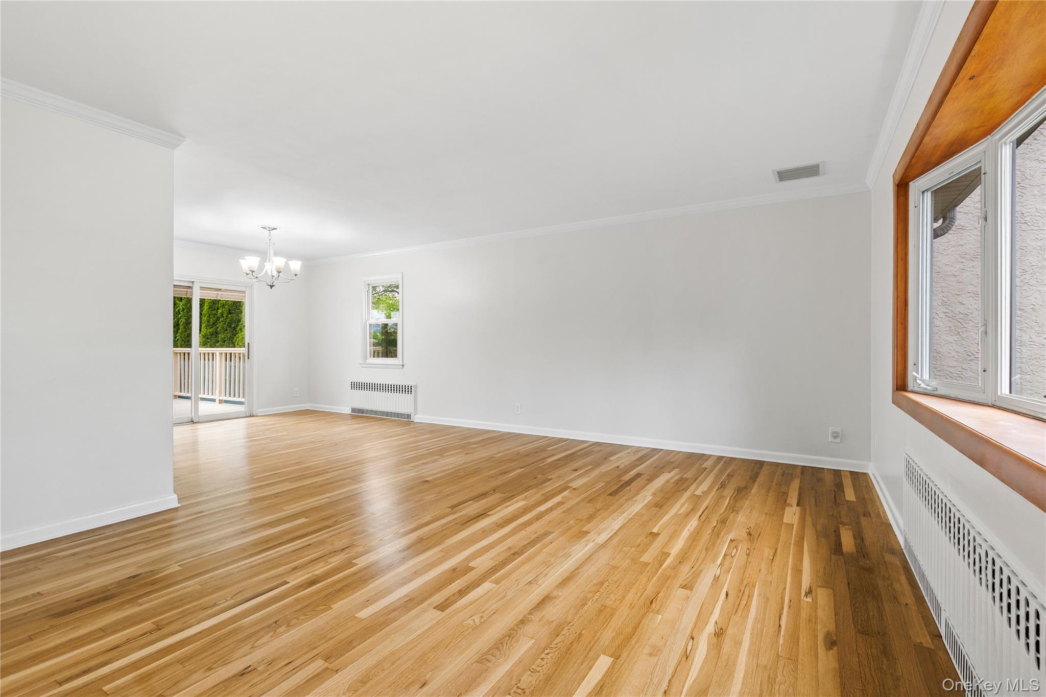 46 Mathews Street Harrison, NY 10528 - Photo 4 of 30 wooden floor in an empty room with a window