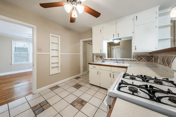 a kitchen with a stove and a refrigerator