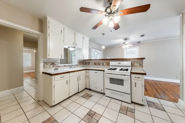 a kitchen with granite countertop cabinets stainless steel appliances and a sink
