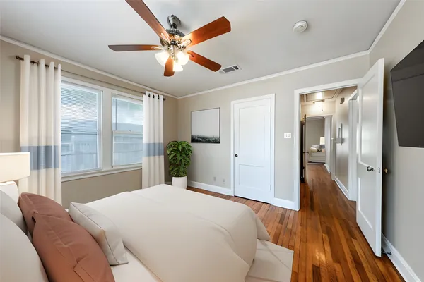 a bedroom with a bed and a large window