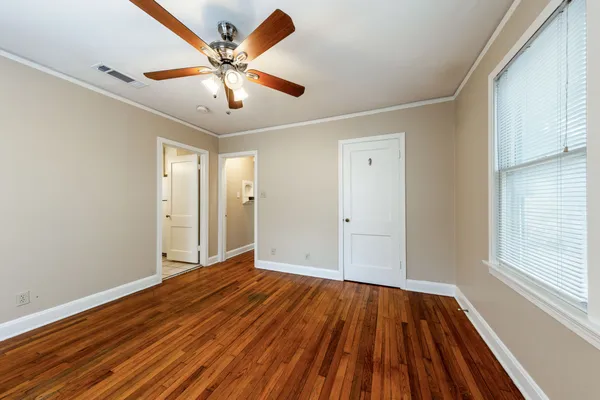 a view of an empty room with wooden floor