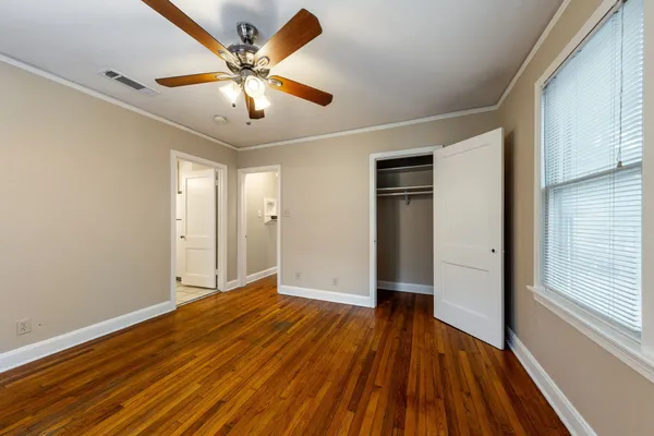 a view of an empty room with wooden floor