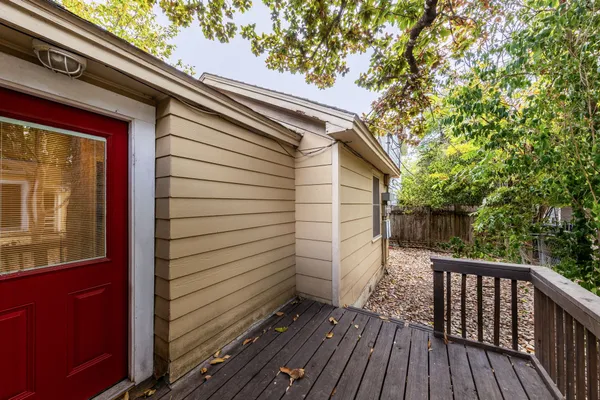 a view of deck with wooden floor and fence next to a yard