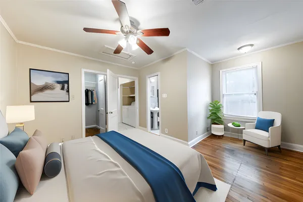 a bedroom with a bed couch and window