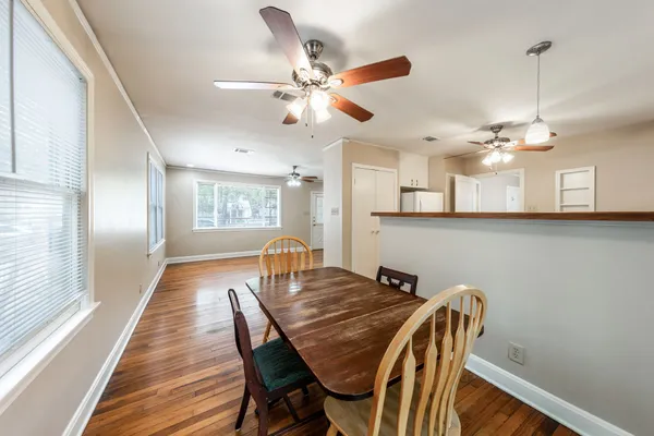 a view of a dining room with furniture and wooden floor