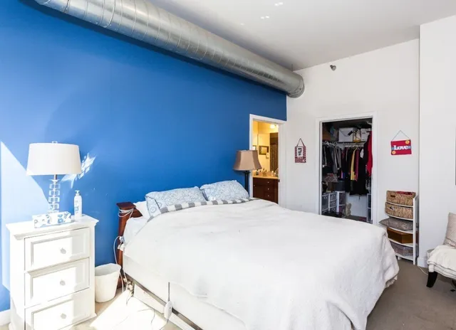 a bed room with a bed and a view of bathroom