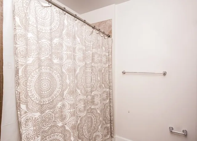 a bathroom with a shower curtain