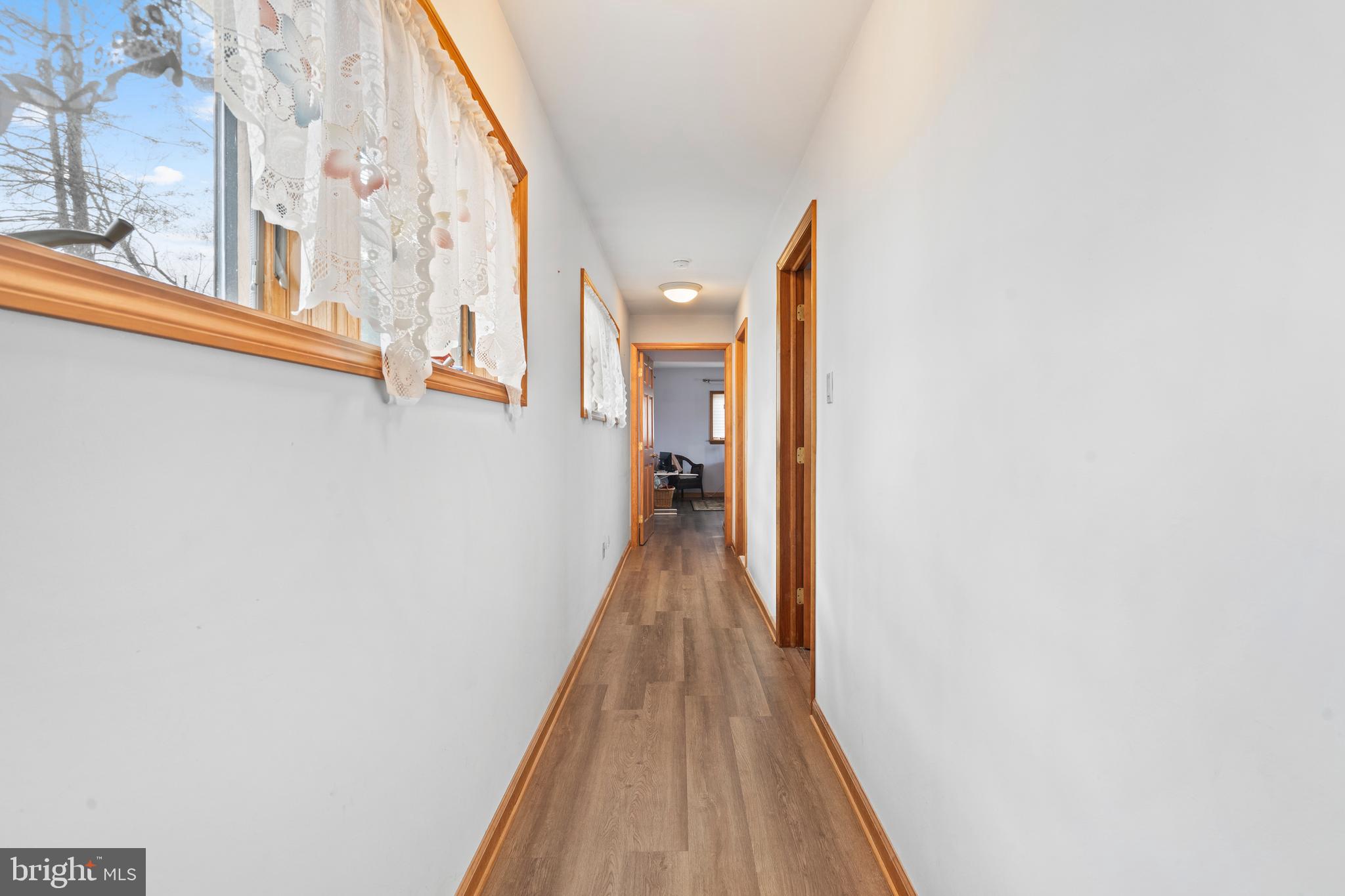 164 Trenton Road Langhorne, PA 19047 - Photo 18 of 51 a view of a hallway with wooden floor and a potted plant