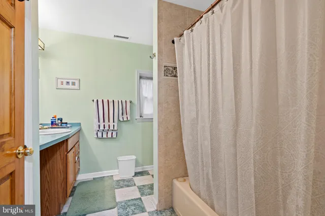 a bathroom with a toilet a sink and curtain