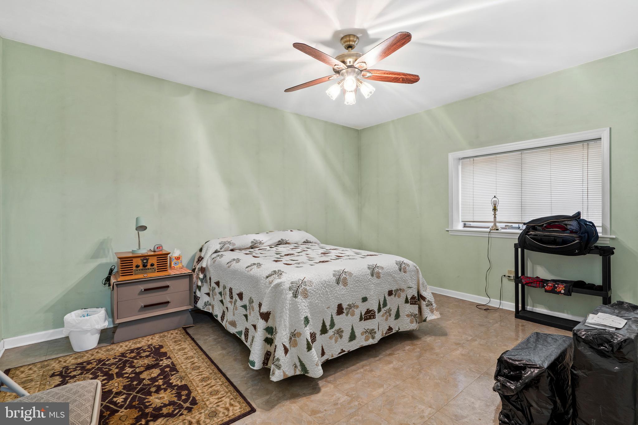 164 Trenton Road Langhorne, PA 19047 - Photo 31 of 51 a bedroom with a bed and a chandelier