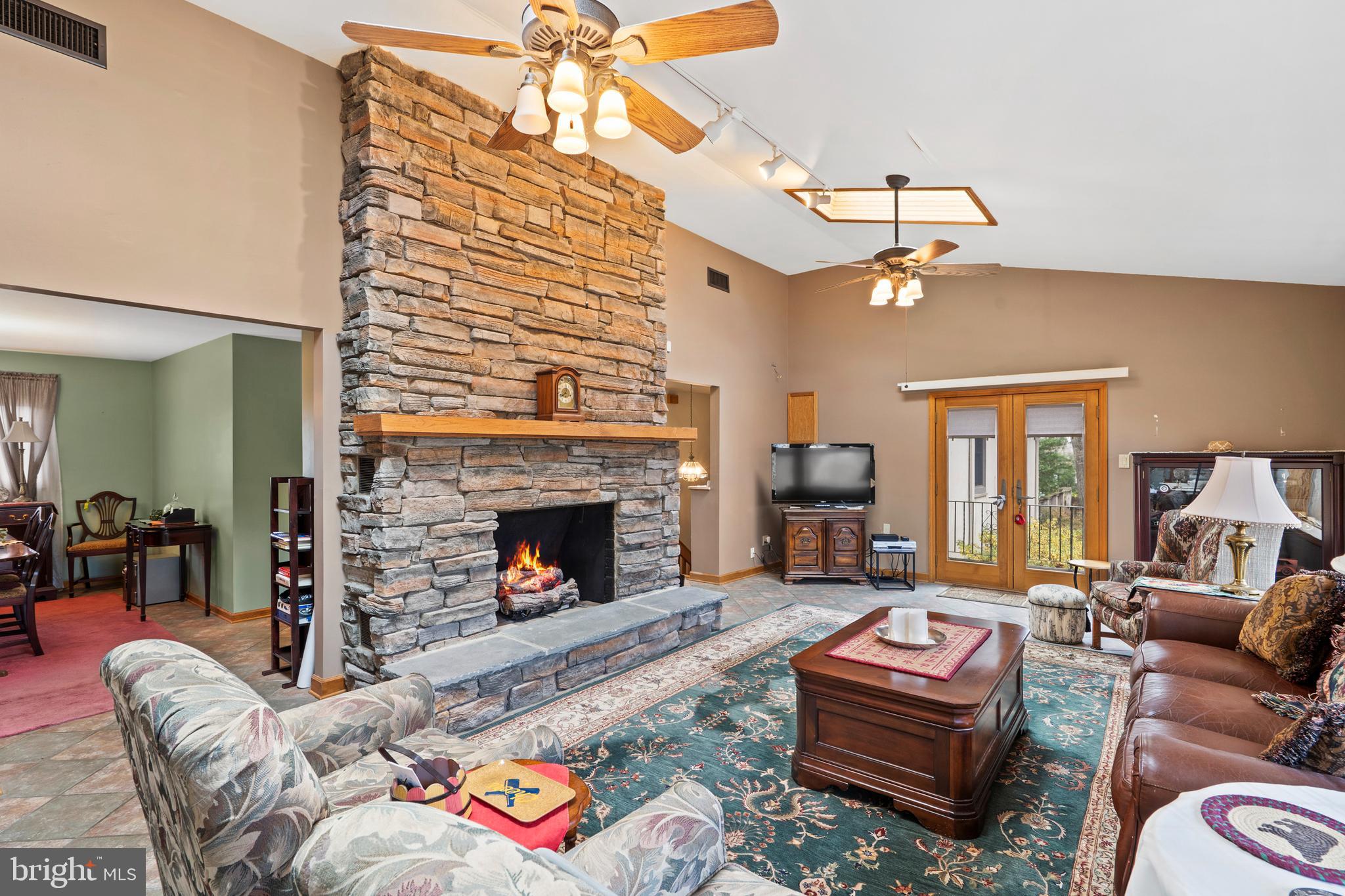 164 Trenton Road Langhorne, PA 19047 - Photo 8 of 51 a living room with furniture a fireplace and a chandelier