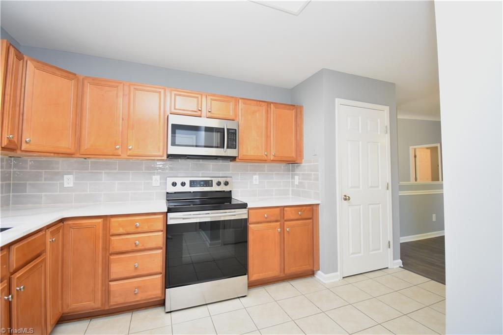 3910 Ribbon Grass Terrace Greensboro, NC 27405 - Photo 11 of 24 Every kitchen needs a pantry and this home does not disappoint.