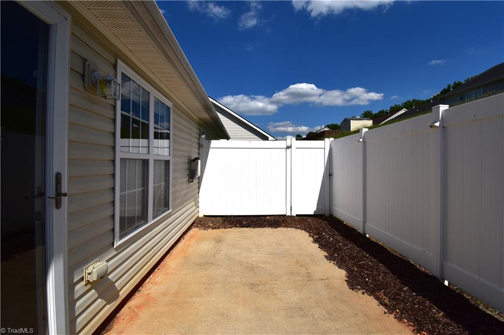 3910 Ribbon Grass Terrace Greensboro, NC 27405 - Photo 23 of 24 What home tour would be complete without a view of the fenced patio.