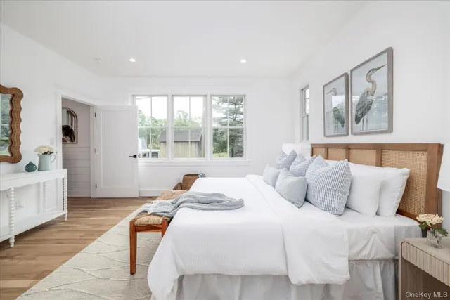 a bedroom with a large bed and a window