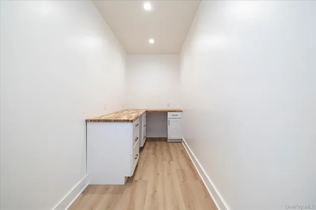 a view of a room with wooden floor