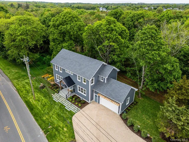 a aerial view of a house with a yard table and chairs