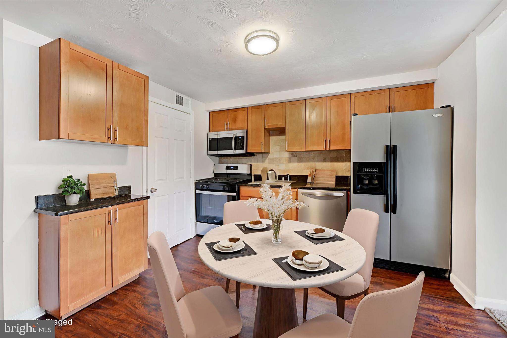 4436 Annapolis Road Halethorpe, MD 21227 - Photo 3 of 30 a kitchen with a dining table and chairs