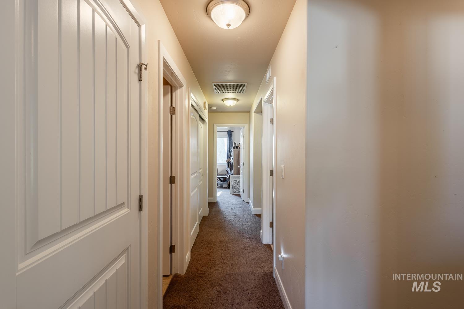 1186 East Observation Street Meridian, ID 83642 - Photo 20 of 33 Interior hallway with neutral-toned walls, recessed lighting, and a brown carpeted floor