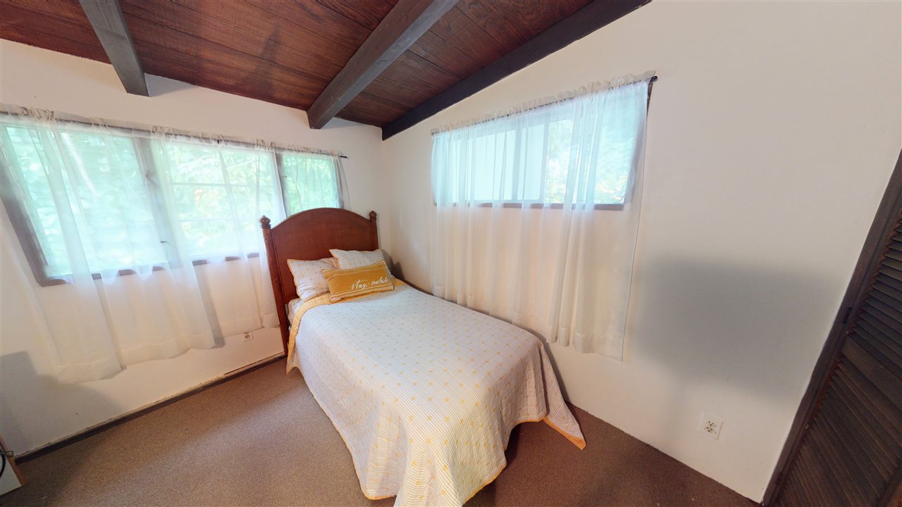 307 West Kuiaha Road Haiku, HI 96708 - Photo 16 of 30 a bedroom with a bed and a window