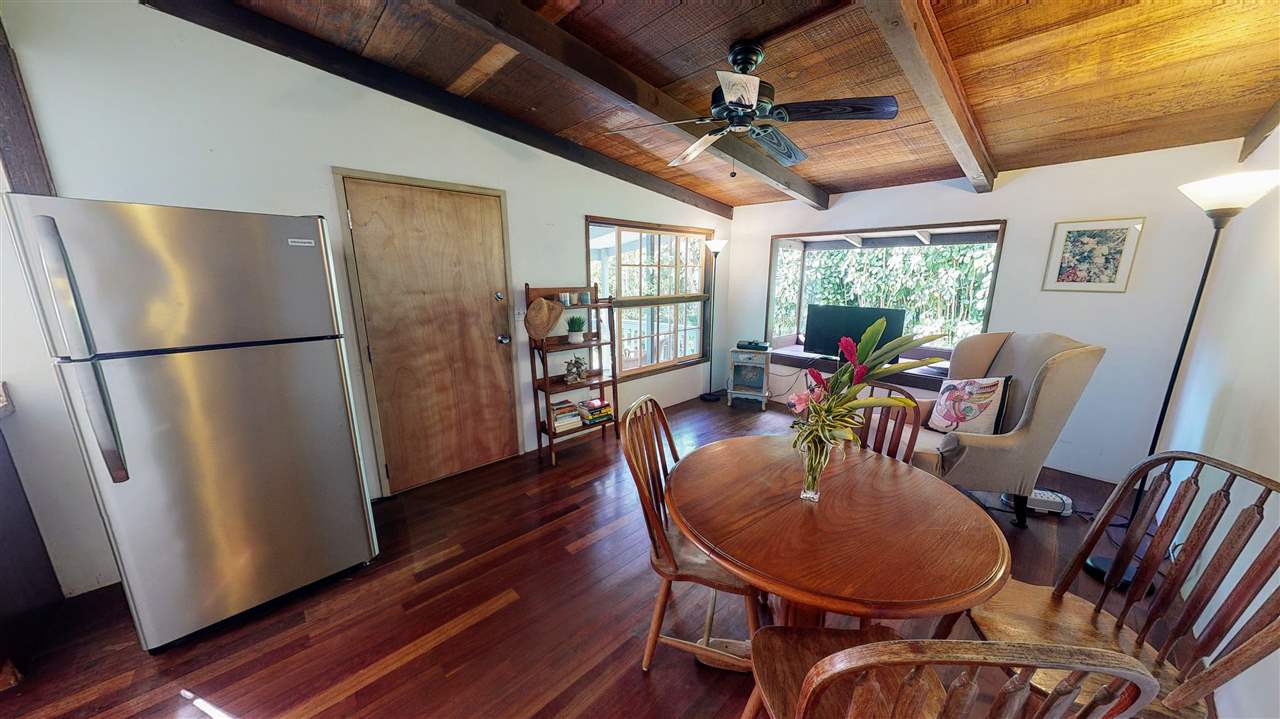 307 West Kuiaha Road Haiku, HI 96708 - Photo 8 of 30 a dining room with furniture a chandelier and wooden floor