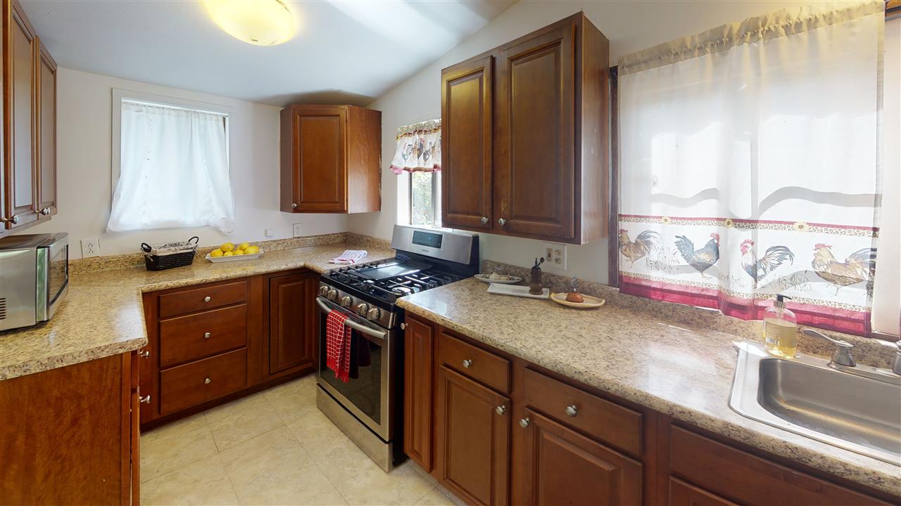 307 West Kuiaha Road Haiku, HI 96708 - Photo 10 of 30 a kitchen with stainless steel appliances granite countertop a sink stove and cabinets