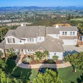 an aerial view of residential houses with outdoor space and river