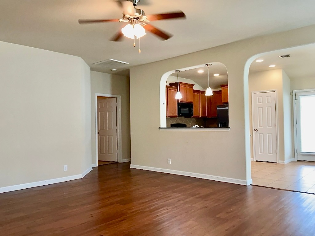 720 Noatak Trail Pflugerville, TX 78660 - Photo 5 of 20 an empty room with wooden floor and a ceiling fan