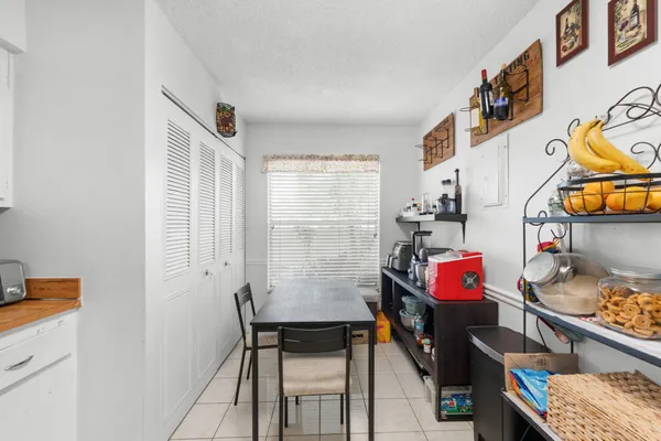 a view of a room that has a table and a chair in it