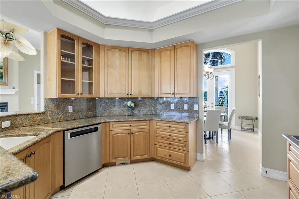309 Rookery Court Marco Island, FL 34145 - Photo 18 of 49 a kitchen with stainless steel appliances granite countertop a sink and cabinets