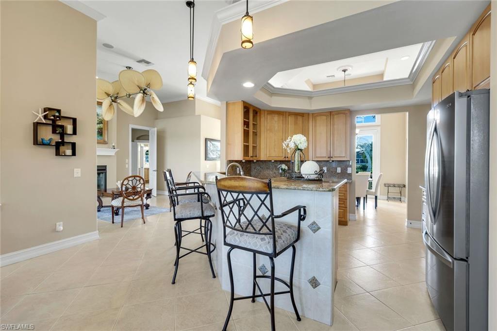 309 Rookery Court Marco Island, FL 34145 - Photo 20 of 49 a view of a dining room with furniture and chandelier