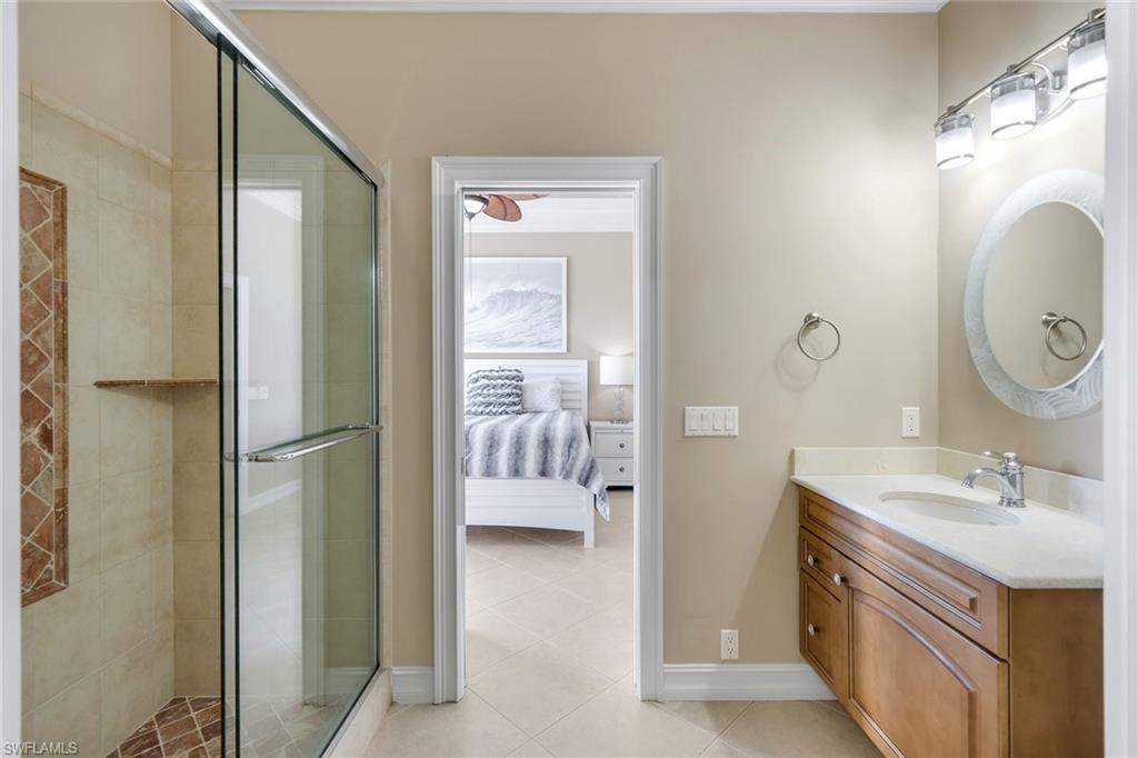 309 Rookery Court Marco Island, FL 34145 - Photo 34 of 49 a en suite bathroom with a sink and a mirror